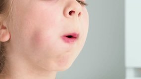 Rotate the tongue in the mouth. The child does an exercise for speech. Exercise with a speech therapist, a speech pathologist and a speech coach. Mouth large