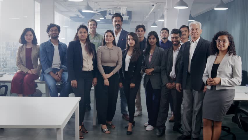 A happy confident large group or team of diverse Asian Indian male and female corporate office executives or colleagues folding hands together and looking at the camera in modern start up business  Royalty-Free Stock Footage #1104952161