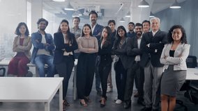 A happy confident large group or team of diverse Asian Indian male and female corporate office executives or colleagues folding hands together and looking at the camera in modern start up business  - Powered by Shutterstock - Get 15% off with code: PIKWIZARD15