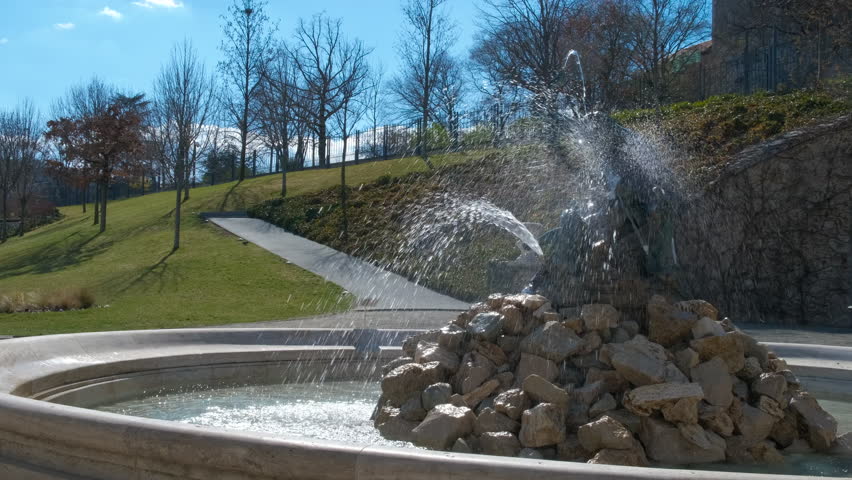 Fountain in renaissance gardens in hungary. A nice summer garden with renaissance fountain against blue sky in Budapest.