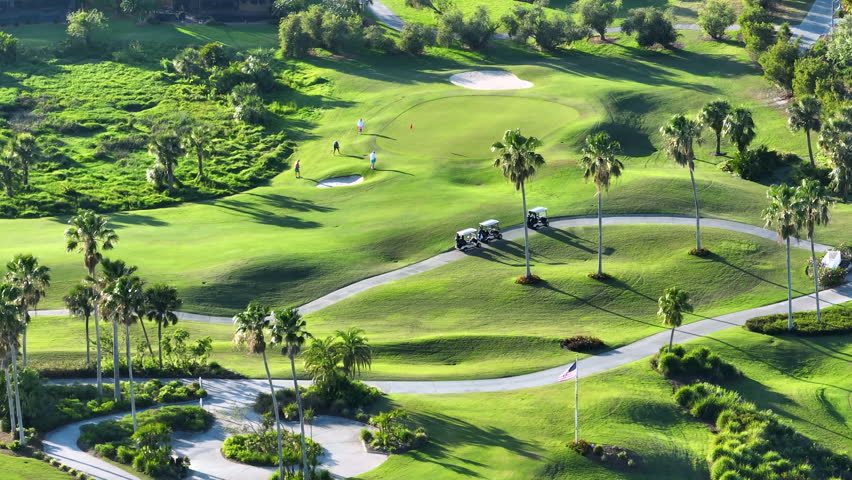 Professional golf players practicing on golf course in sunny Florida. Outdoor activities of rich people
