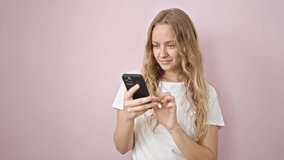 Young blonde woman smiling confident having video call over isolated pink background