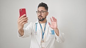 Young latin man doctor smiling confident having video call over isolated white background