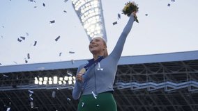 Young Female Athlete Celebrates a Win on a podium, receives a gold medal. Super slow motion, shot on RED cinema camera - Powered by Shutterstock - Get 15% off with code: PIKWIZARD15