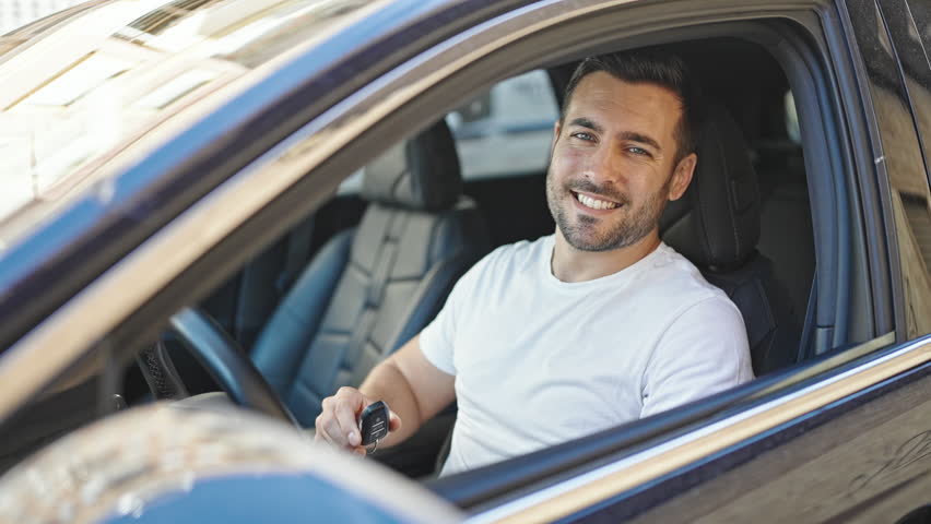 Young hispanic man smiling confident holding key of new car at street Royalty-Free Stock Footage #1104968547