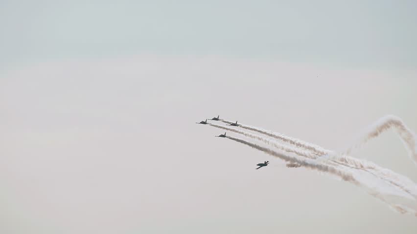 Bizarre aerobatics in the sky are performed by a group of jet fighters