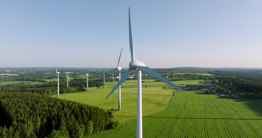 Wind farm during sunset in a rural field