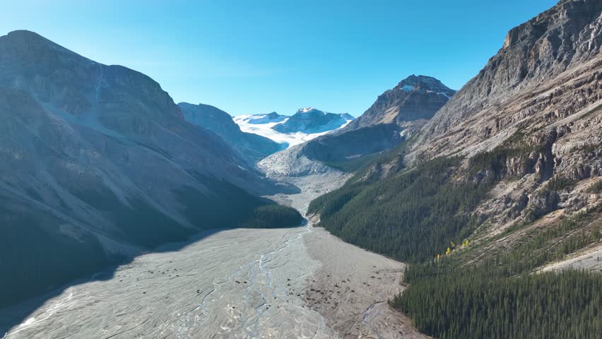 Drone view of the azure lake in the glacier valley. View of the moraines. Landscape from the air.  River on a moraine. Landscape from drone. Abstract view for wallpaper. Alberta, Canada.