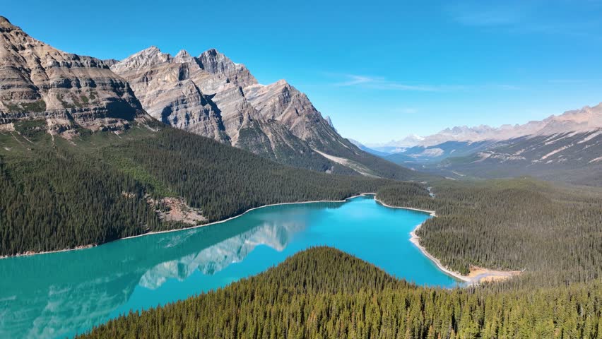 Lake Peyto, Banff National Park, Alberta, Canada. A huge panorama of Landscape during daylight hours. A lake in a river valley. Mountains and forest. Natural landscape.