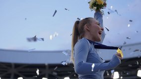 Young Female Athlete Celebrates a Win on a podium, receives a gold medal. Super slow motion, shot on RED cinema camera - Powered by Shutterstock - Get 15% off with code: PIKWIZARD15