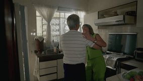Romantic senior couple dancing in kitchen setting, retired older man and woman engaged in dance at home, authentic domestic lifestyle scene - Powered by Shutterstock - Get 15% off with code: PIKWIZARD15