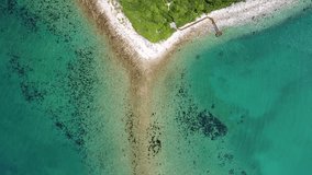 Video from a quadrocopter of an unusual triangular-shaped beach, turquoise clear water, waves coming towards each other (6)
