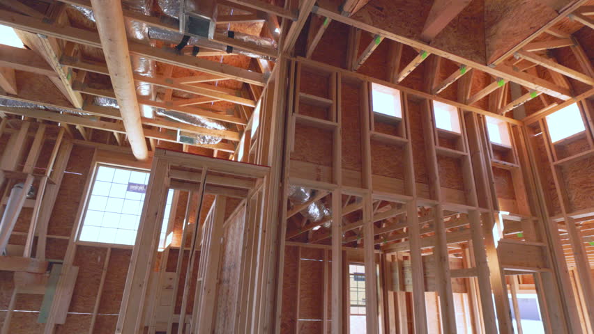 New Southwest Home Construction Interior Framing Walk Through Look Up Spin Around. slow motion view in home construction framing interior move along look up and spinning Royalty-Free Stock Footage #1104983151