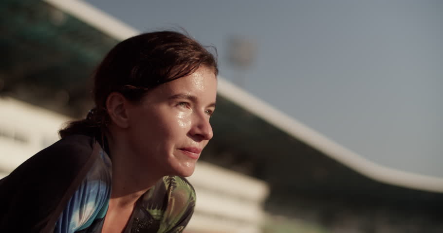 Sweaty tired sportswoman breathing heavily after training