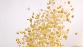 Ripe corn grains filmed in a photo studio on white background with video lighting. Many ripe corn grains Falling into Water in Slow Motion. - Powered by Shutterstock - Get 15% off with code: PIKWIZARD15