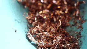 Twisted spiral copper shavings. Copper scrap materials recycling. chip waste after machining metal parts on a cnc lathe. Closeup. Old metalwork machine, industrial machines in a old factory. - Powered by Shutterstock - Get 15% off with code: PIKWIZARD15
