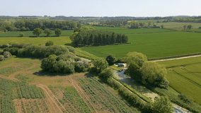 This aerial drone video shows the countryside in Lincolnshire, England. The video is made near the Grantham canal which is surrounded by grain fields.