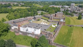 This aerial drone video shows the Carlisle Castle. Carlisle is a town in North England in the province Cumbria. The old medieval castle is in the middle of a large park. 