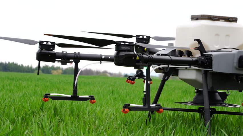 Starting and Launching Agriculture Drone With Sprayers on Green Farming Land, Close Up Royalty-Free Stock Footage #1104989703