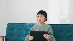 Asian little girl using a tablet PC.