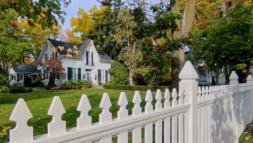 View of a small town in Canada with white picket fence in autumn