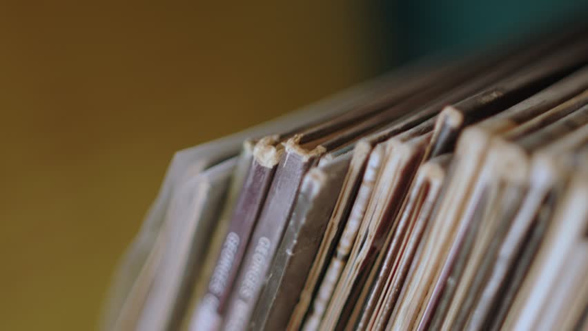 Edges Of Vinyl Records Stacked In The Shelf. closeup, sideways Royalty-Free Stock Footage #1104999411