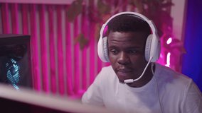 Portrait Of African Man Gamer Playing Online And Streaming, Talking To Mic On Headset, Portrait In Room, Professional Video Game Player, Cyber Sport And Entertainment In Web