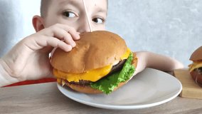 USA Independence Day. USA Independence Day celebration. American flag burgers. The boy eats a burger prepared for the independence day of the USA - Powered by Shutterstock - Get 15% off with code: PIKWIZARD15