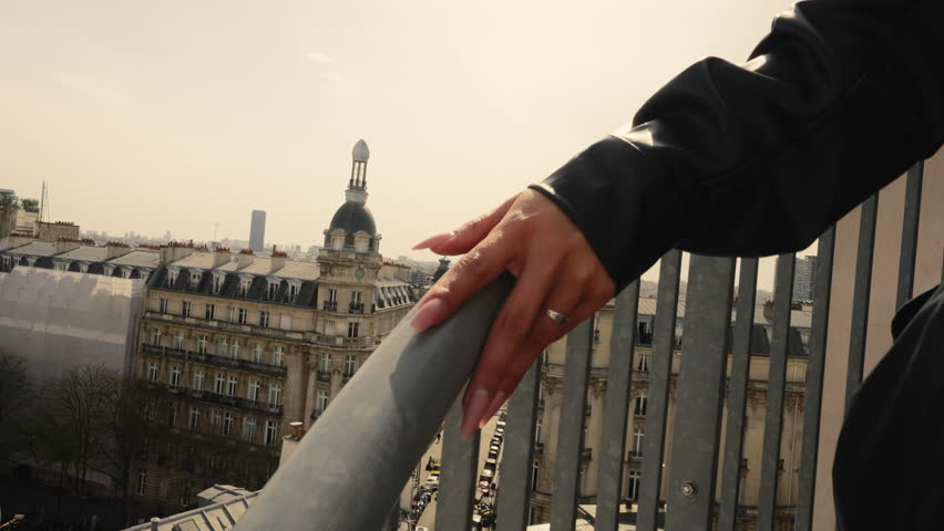 Close up of a young woman's hand going up outdoor stairs, with the Paris cityscape in the background, France Royalty-Free Stock Footage #1105001459