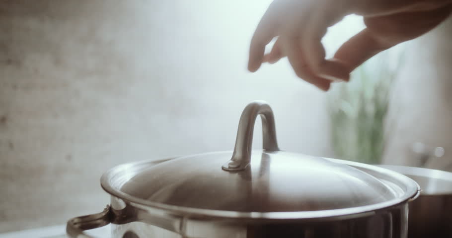Opening lid from pot of boiling soup to spice it with fresh herbs, close up Royalty-Free Stock Footage #1105008535