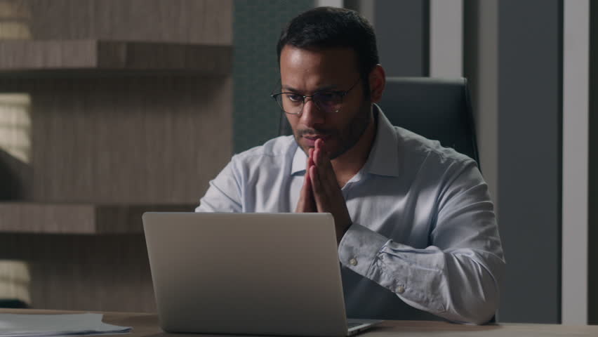 Indian man businessman American investor broker rub hands hoping wish to win lose with laptop at office feel annoyed business problems with computer angry bad result failure data loss password wrong Royalty-Free Stock Footage #1105014143