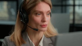 Caucasian middle-aged adult woman in headset with computer talking close up businesswoman helpline agent operator talk answer business call support customer service. Distant teacher video class lesson