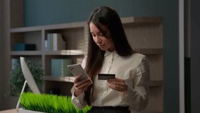 Caucasian business girl standing office worker businesswoman woman executive bank manager with phone and credit card banking online service shopping with smartphone currency exchange buying purchase - Powered by Shutterstock - Get 15% off with code: PIKWIZARD15