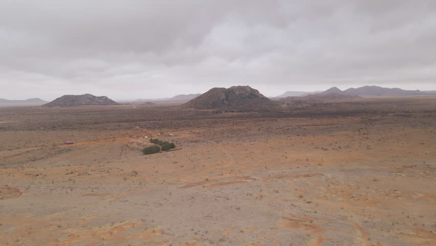 Aerial Drone Fly Above Desert Ranch in Big Bend National Park, Dry Landscape in Cloudy Dramatic Skyline, Texas USA