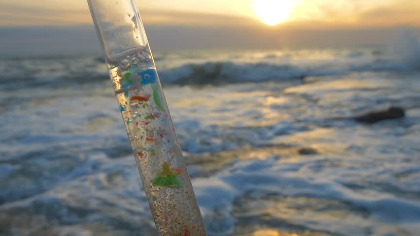 Microplastics in the oceans, microplastic research. Colorful plastic particles in water. Taking plastic samples onshore and from open ocean. Researches collecting marine particles from ocean surface.  Royalty-Free Stock Footage #1105020993