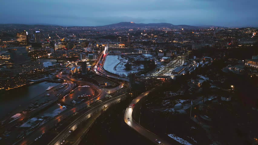Aerial view of Oslo Downtown Skyline, Norway. Financial district and business centers in smart urban city in Europe. Skyscraper and high-rise buildings at night.