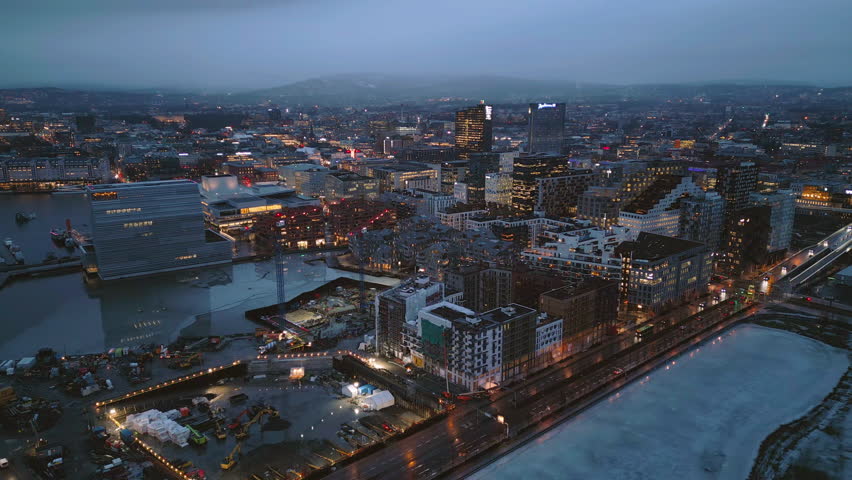 Aerial view of Oslo Downtown Skyline, Norway. Financial district and business centers in smart urban city in Europe. Skyscraper and high-rise buildings at night.