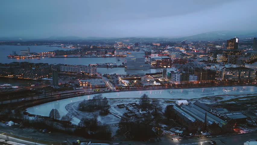 Aerial view of Oslo Downtown Skyline, Norway. Financial district and business centers in smart urban city in Europe. Skyscraper and high-rise buildings at night.