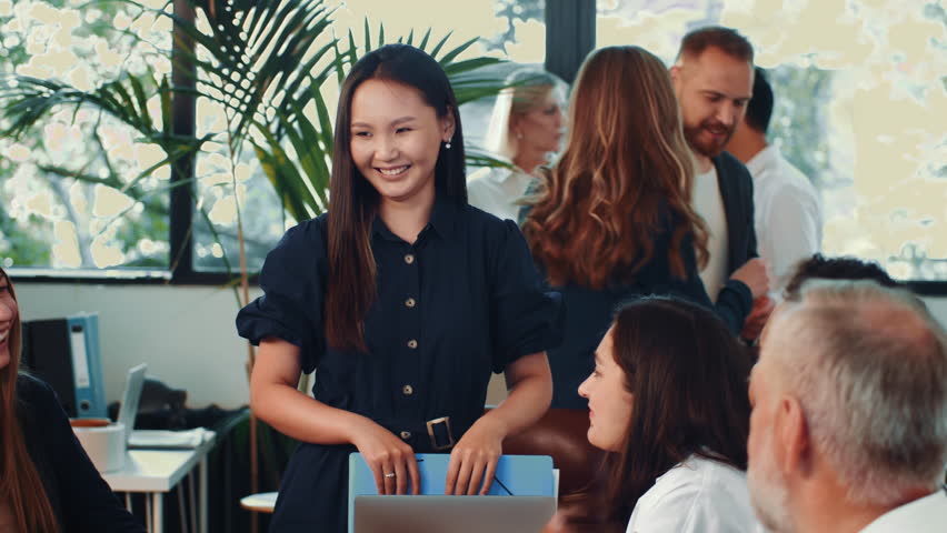 Young female team leader congratulates team on success. Happy diverse team of colleagues celebrate good news Royalty-Free Stock Footage #1105030059
