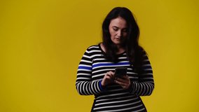 4k video of one woman posing for a video on yellow background.
