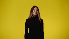 4k video of one girl posing for a video over yellow background.