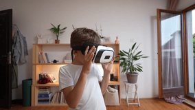 boy male caucasian child at home enjoy virtual reality VR headset hand-held UGC User generated content amateur video 