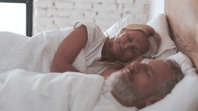 The middle age couple sleeping in the bed - Powered by Shutterstock - Get 15% off with code: PIKWIZARD15