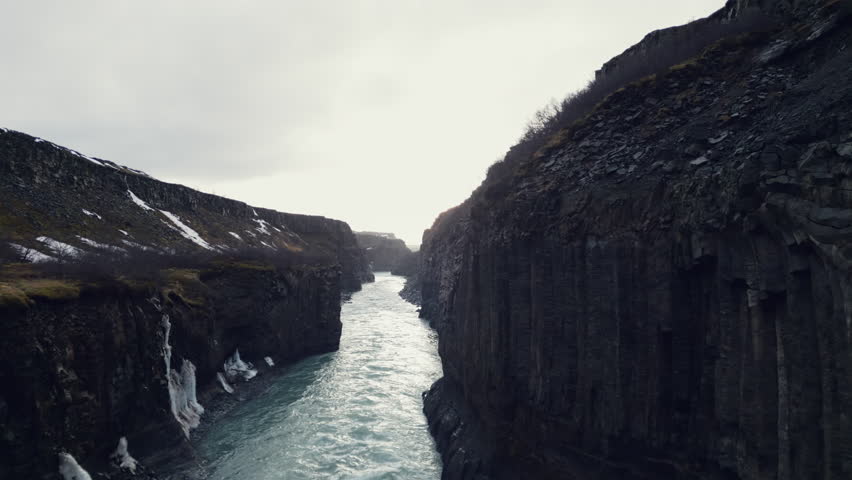 Top down view of Stuolagil, a majestic canyon with volcanic basalt ...