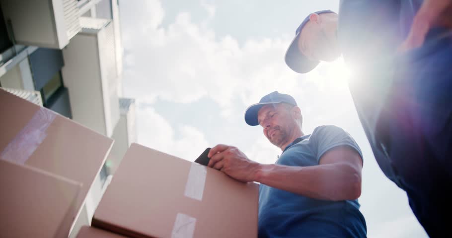 Mover Workers Near House Relocation Van. Professional Delivery Royalty-Free Stock Footage #1105046575