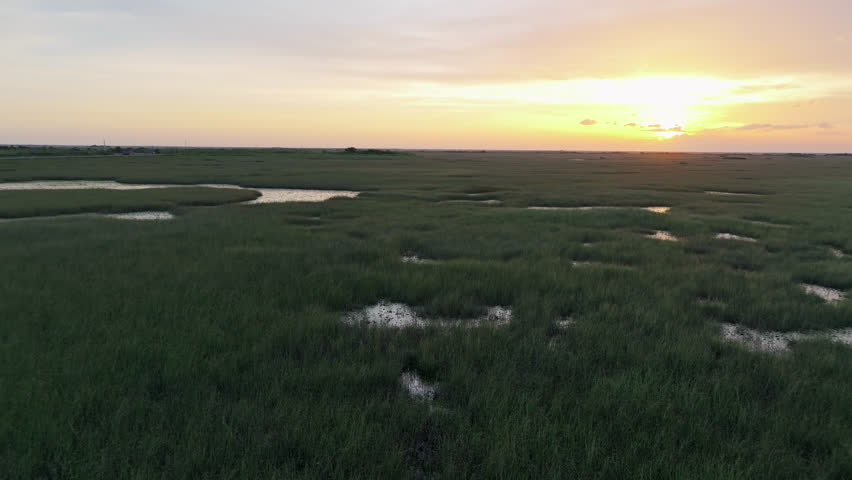 Aerial view of dramatic cloudy sunset landscape over Everglades at golden hour, Florida.
