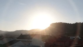 time lapse video of sunset with the mountains on the horizon