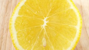 Captivating macro lemon: Close-up video captures a mesmerizing half lemon. Its peel shines, flesh bursts with citrus goodness, and fragrance invigorates. Detailed shots unveil pulp, seeds. 4K HDR
