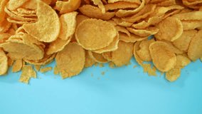Succulent corn flakes take center stage, showcasing their irresistible texture and golden allure. Appetizing crunch and mouthwatering visuals of these delectable breakfast delights. Macro video. 4K
