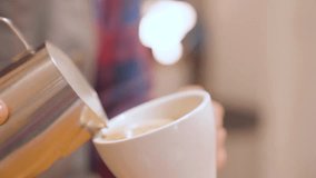 Barista prepares flat white coffee with latte art on surface. Closeup - Powered by Shutterstock - Get 15% off with code: PIKWIZARD15
